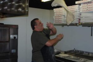 Owner Steve Lushaj in Action Tossing a Pizza